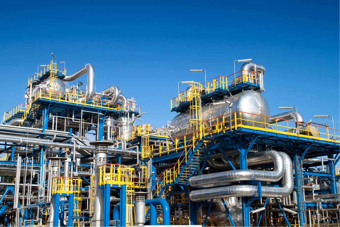 Exterior view of stainless steel tanks and piping at processing facility