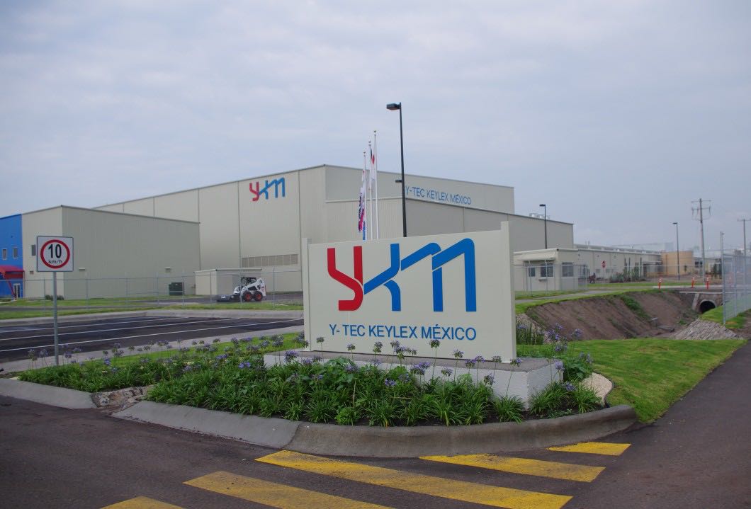 Exterior of the YKM facility with sign in the front