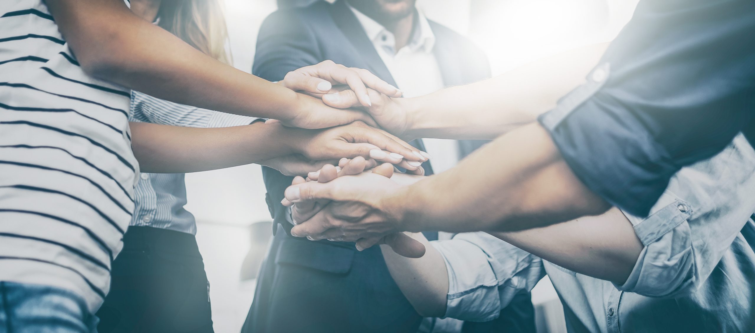 hands stacked together to show unity